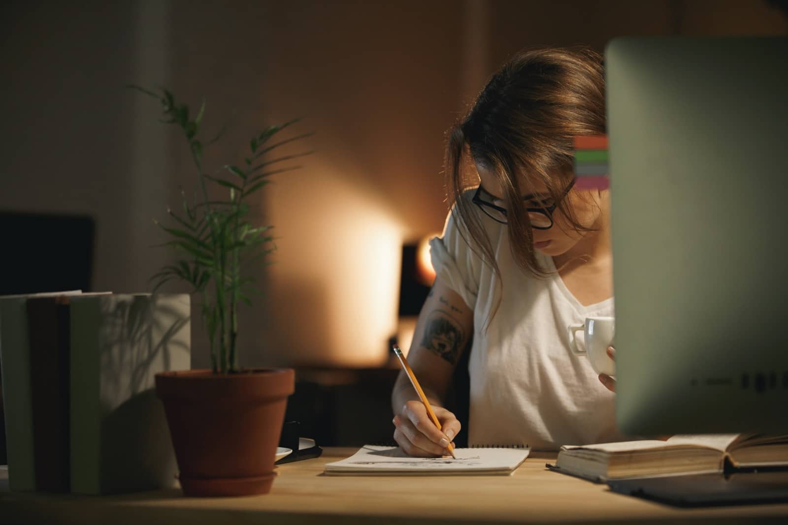 concentrated-young-woman-designer-writing-notes-using-computer.jpg